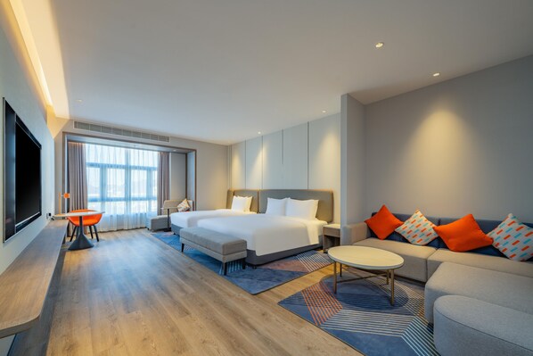 A modern hotel room with a large bed, a sofa, a TV, and a desk. - Holiday Inn Express Suzhou Luzhi (Suzhou)
