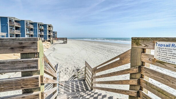 A wooden staircase leading to a beach with a sign indicating beach access rules. - North Topsail Condo - Steps to Beach! (North Topsail Beach)