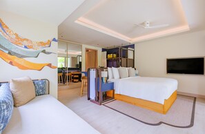 A modern hotel room with a large bed, a desk, a chair, and a TV. - Avani+ Fares Maldives Resort (Fares)