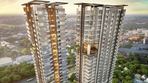 A high-rise residential building with multiple balconies, a central courtyard, and surrounding greenery. - BeSS Mansion Hotel Surabaya (Wonocolo)