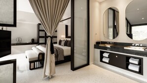 A modern bathroom with a large mirror, a bathtub, and a vanity with a sink and towel racks. - TIA Wellness Resort (Da Nang Municipality)