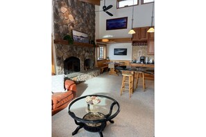 Cozy living area with a fireplace, comfortable seating, and a coffee table.