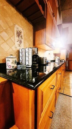 Fully equipped kitchen with a coffee maker, toaster, and kettle, plus a convenient countertop and ample storage.