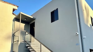 A modern building with a spiral staircase leading to an upper level.