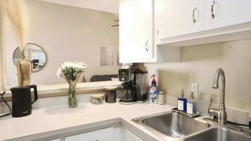 Modern, clean kitchen with all the essentials—including a double sink and countertop space to prep with ease.