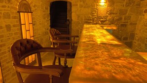 A room with a long wooden table, two chairs, stone walls, and a stone fireplace. - Dionysos 1789 Boutique Hotel (Foça)