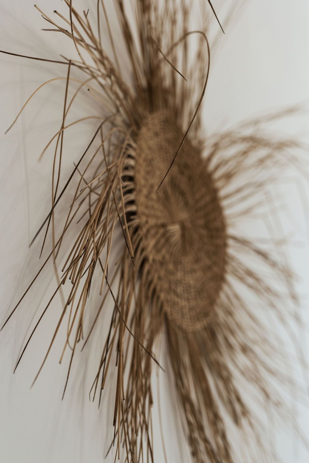 A close-up of a textured, circular object with multiple protruding elements, possibly a decorative item or part of a piece of furniture.