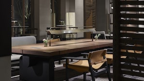 A modern dining area with a long wooden table, multiple chairs, and three large woven pendant lights. - Angsana Chengdu Wenjiang (Chengdu)
