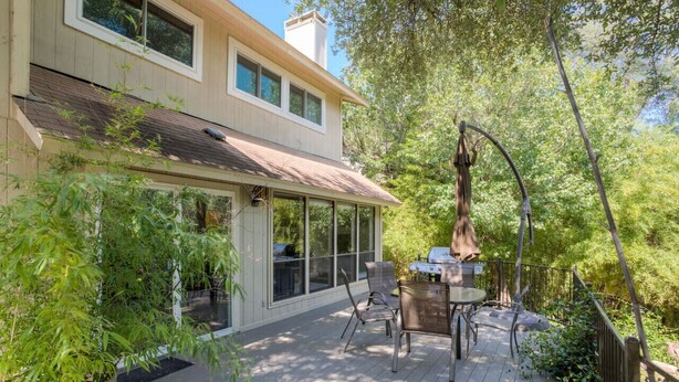 A house with a deck, large windows, and outdoor furniture. - Greenbelt Access & Views, Close to DT (Austin)