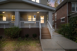 A two-story house with a front porch, a staircase leading to the entrance, and a mailbox. - Newly remodeled 4BRs next to OSU&Expo, 2 FREE Parking. (Columbus)