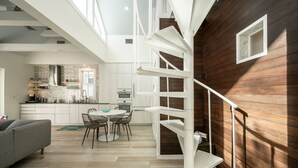 A modern interior with a staircase, a dining area, and a kitchen. - THE CLASSY CONCH- Old Town Key West (Key West)