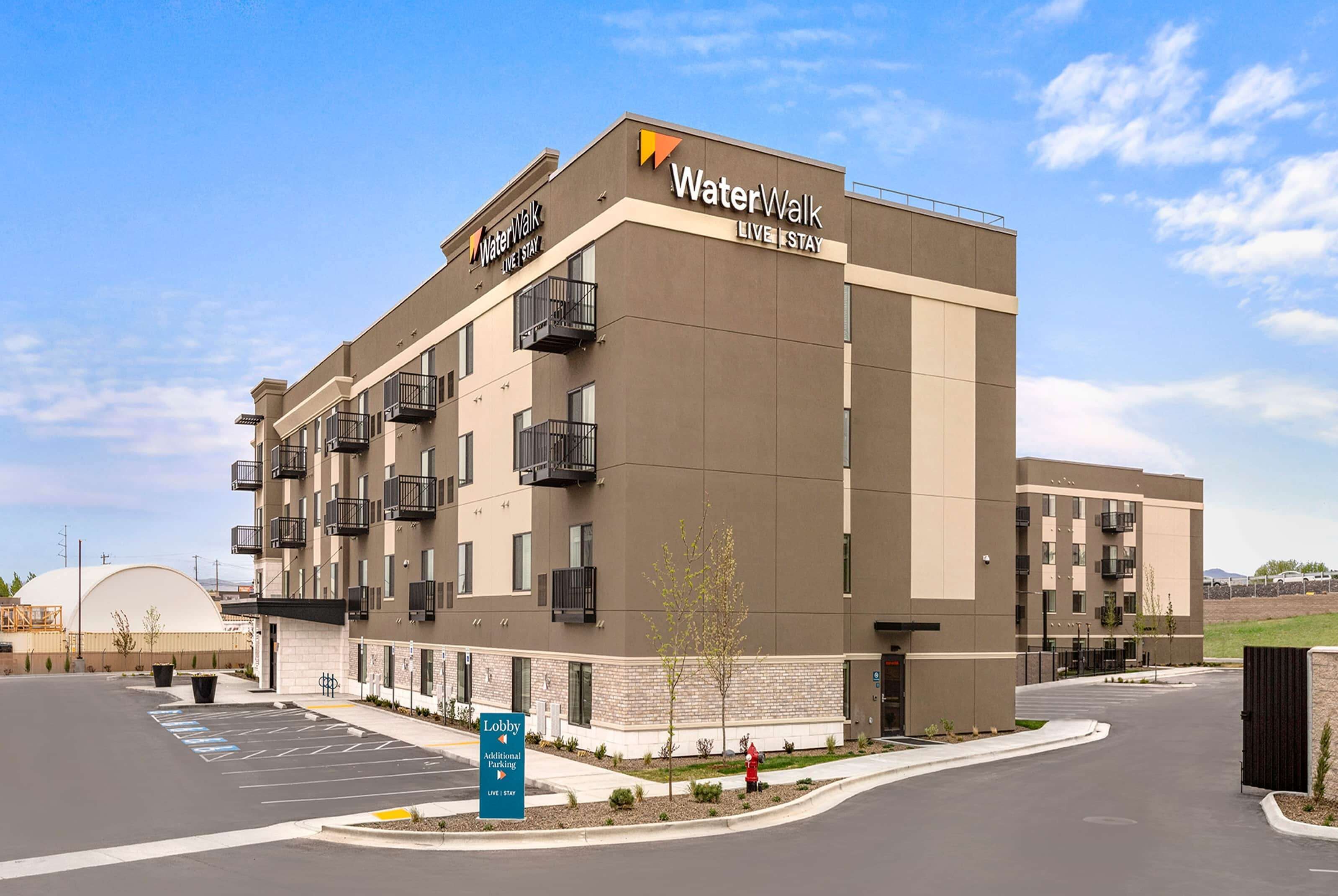 A modern building with a sign reading "WaterWalk Live Stay".