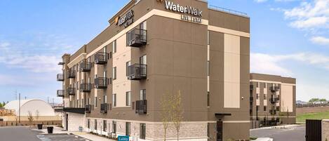 A modern building with a sign reading "WaterWalk Live Stay".
