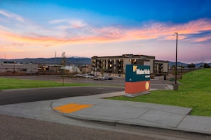 A WaterWalk hotel with a modern design, located near a road with a pedestrian crossing.