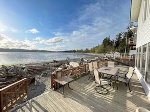 Enjoy a serene lakeside view from this outdoor deck, perfect for dining or relaxation.