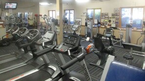 A gym with multiple treadmills, stationary bikes, and weight machines. - Bali’s Cottage - Cozy Poconos Stay • WLE Amenities • Fire Pit (Lake Ariel)