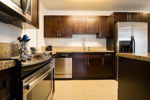 Fully equipped kitchen with oven, dishwasher, and refrigerator.