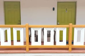 Two doors with numbers and letters mark the entrance to this building's outdoor area.