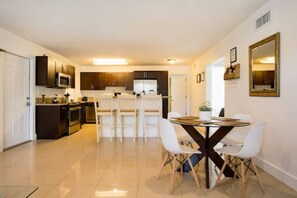Enjoy meals in this spacious dining area with a central table and comfortable seating.