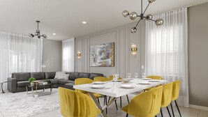 Ein modernes Wohnzimmer mit einem grauen Sofa, gelben Sesseln und einem Esstisch, gedeckt für vier Personen.