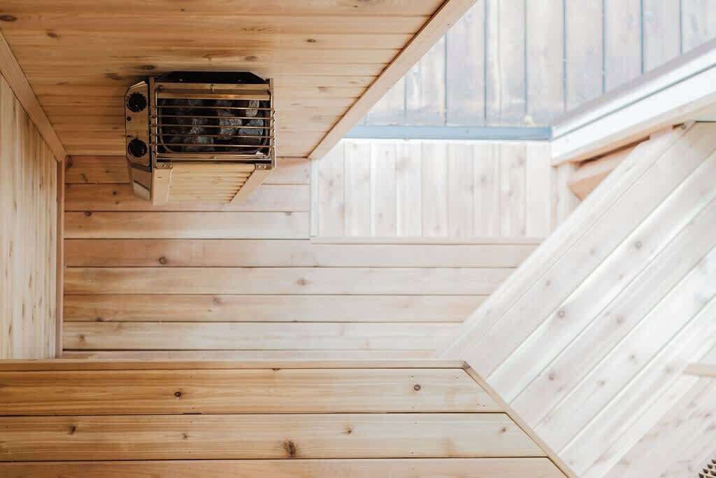 A wooden interior with a built-in heater and a sloped ceiling.
