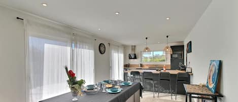 A modern kitchen with a dining area.