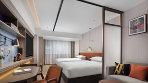 A hotel room with a bed, a desk, a chair, a sofa, and a small table. - Home2 Suites by Hilton Chengdu Kuanzhai Alley (Chengdu)