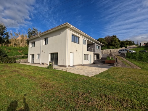 ApartamentopraiadoAlmoxarife has a peaceful view over the fields and the ocean.