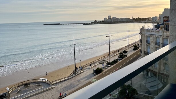 A coastal cityscape with a beach, promenade, and buildings. - Accès direct à la Plage + Garage fermé (Les Sables-d'Olonne)