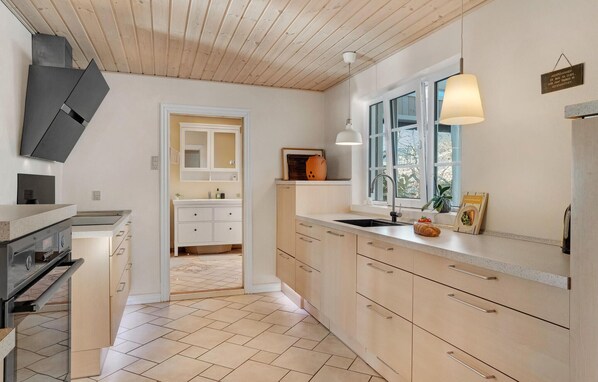 Fridge, stovetop, dishwasher, coffee/tea maker