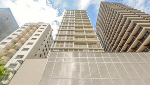 A modern high-rise building with a prominent 'VITACON' sign at the base. - OBA 142 - Super Estúdio Frei Caneca (São Paulo)