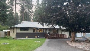 A single-story house with a covered porch, a paved driveway, and a well-maintained lawn. - Evans Corner-A Libby Original (Libby)