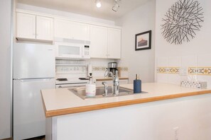 Fridge, coffee/tea maker, cookware/dishes/utensils