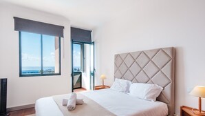 A hotel room with a large bed, a view of the sea through a window, and a balcony. - Varandas Funchal-Near center (Funchal)