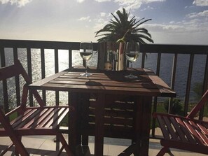 Enjoy a romantic meal for two on this seaside balcony with a table set for a special occasion.