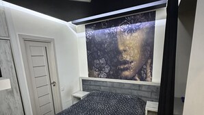 Un dormitorio con cama, ventana con vistas y lámpara en el techo.