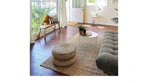 A spacious living room with a large window, a door, and a seating area with a sofa and a chair. - Beachy Boho located in the Heart of Encinitas (Encinitas)