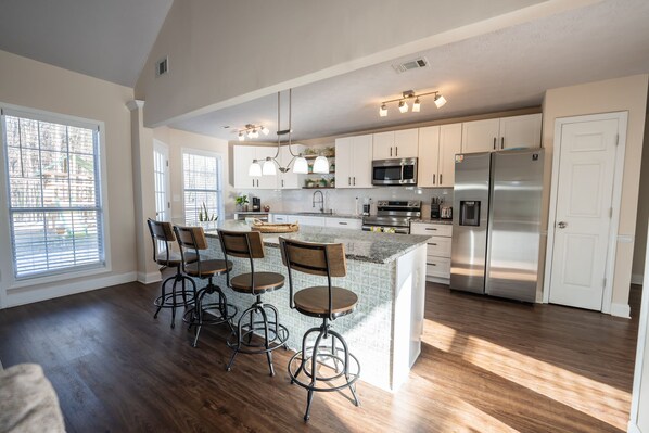 Enjoy cooking in this well-equipped kitchen with a central island and bar stools.