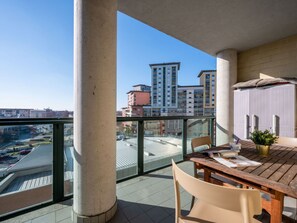 Enjoy a peaceful retreat with a balcony offering a table, chair, and potted plant.