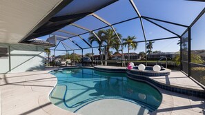A swimming pool with a sunshade structure, lounge chairs, and a hot tub. - Perfect 3 Bedroom House on Charlotte Harbor Area, Charlotte County House 5825 (Charlotte County)