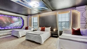 A room with two beds, a large window, and a wall-mounted TV displaying a space scene. - 5 Star Villa Serenade – A Symphony of Luxury (Orlando)