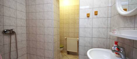 A bathroom with a bathtub, a sink, and a toilet.