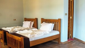 A room with two wooden beds, a wooden bench, and a wooden door. - LAKE NYASA RESORT & CAMPSITE  (Matema)