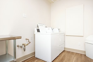 Un'area lavanderia con lavatrice, lavandino e toilette.