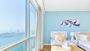 A hotel room with two beds, a large window with a view of a Ferris wheel and water, and a painting on the wall. - Luxury JBR - Al Fattan Full Sea View - Free Beach Resorts Access (Dubai)