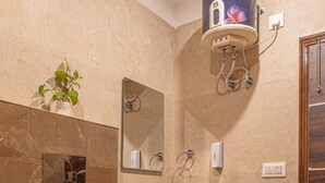 A bathroom with a white toilet, a red cabinet, a sink with a mirror, and a wall-mounted water heater. - The Green Land Kasauli  (Kasauli)