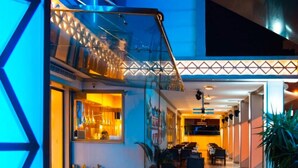 A modern hotel lobby with a glass railing, a seating area, and a staircase. - Aurasia Design Hotel (Marmaris)