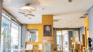A spacious lobby with a polished marble floor, a reception desk, and a large window offering a view of the outside. - Aurasia Design Hotel (Marmaris)
