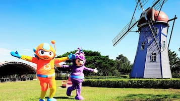 Two mascots in front of a windmill.