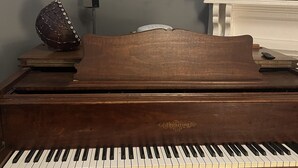 A grand piano in a room with a painting on the wall and a whiteboard. - Rose Music House- 8 min from Broadway (Nashville)